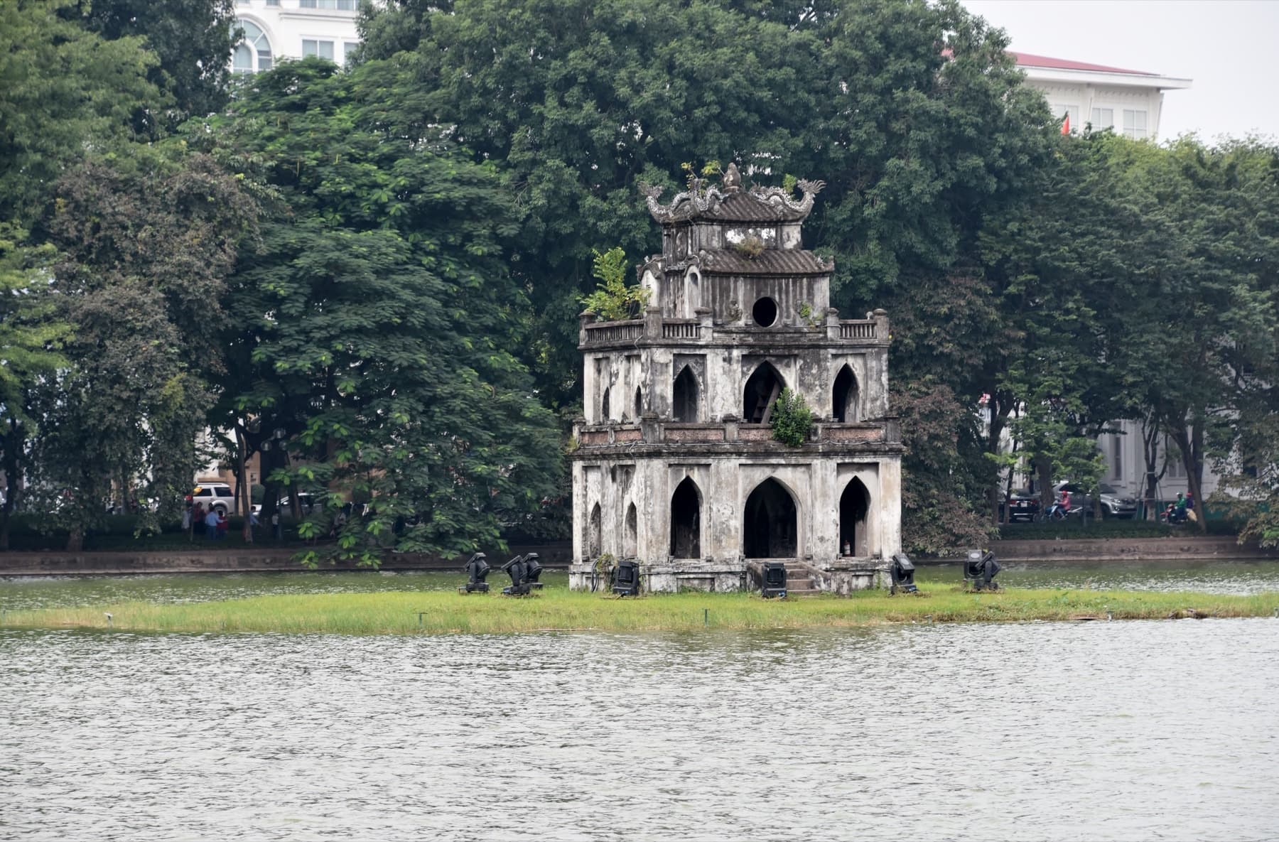 Turtle Tower on Hoan Kiem Lake in Hanoi, photographed in November, with still water and trees in late-autumn light