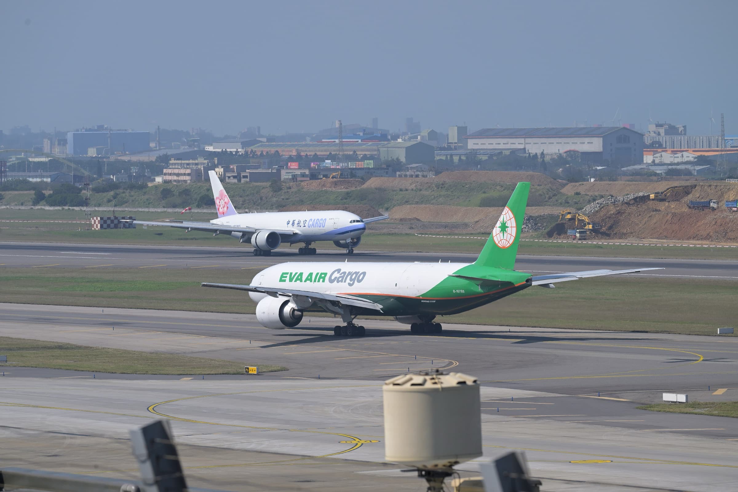EVA Air Cargo and China Airlines Cargo Boeing 777 freighters on the tarmac at Taiwan Taoyuan — AI Chips Are Redrawing Asia’s Air-Cargo Map