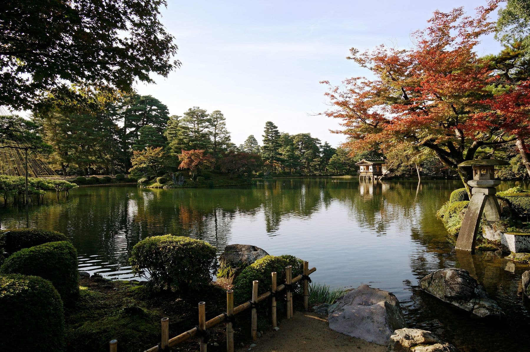 Kenrokuen Garden in Kanazawa with Kotoji stone lantern beside a reflecting pond and autumn maples — Asia’s Best Second Cities for a Longer Stay