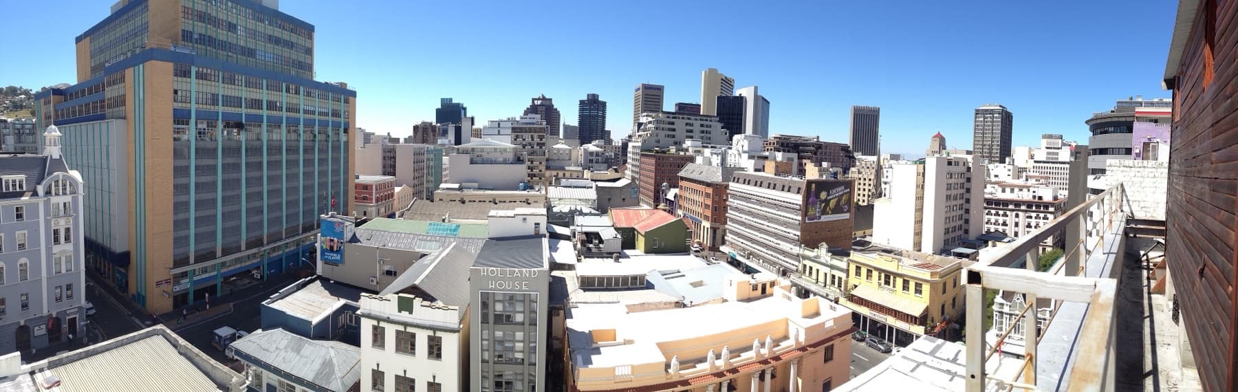 Cape Town CBD rooftops with Holland House and mountain foothills beyond