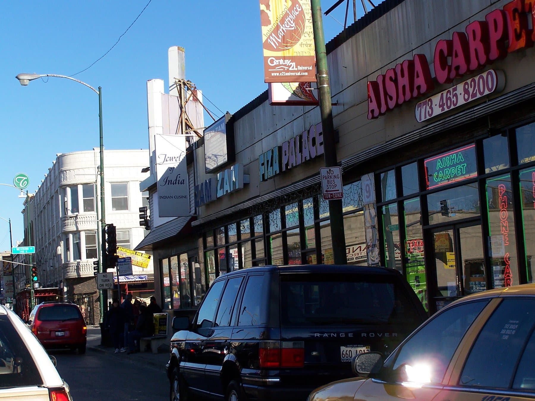 Storefronts along Devon Avenue in Chicago, including signs for Indian cuisine and neighborhood shops