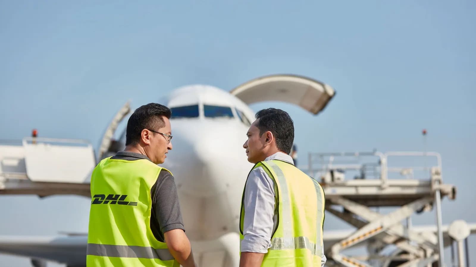 DHL freight operatives standing in front of a DHL-liveried freighter, from the July 2026 TransPac Connect announcement — DHL’s Bangkok–Cincinnati Freighter Maps the New Asia–U.S. Air Cargo Story