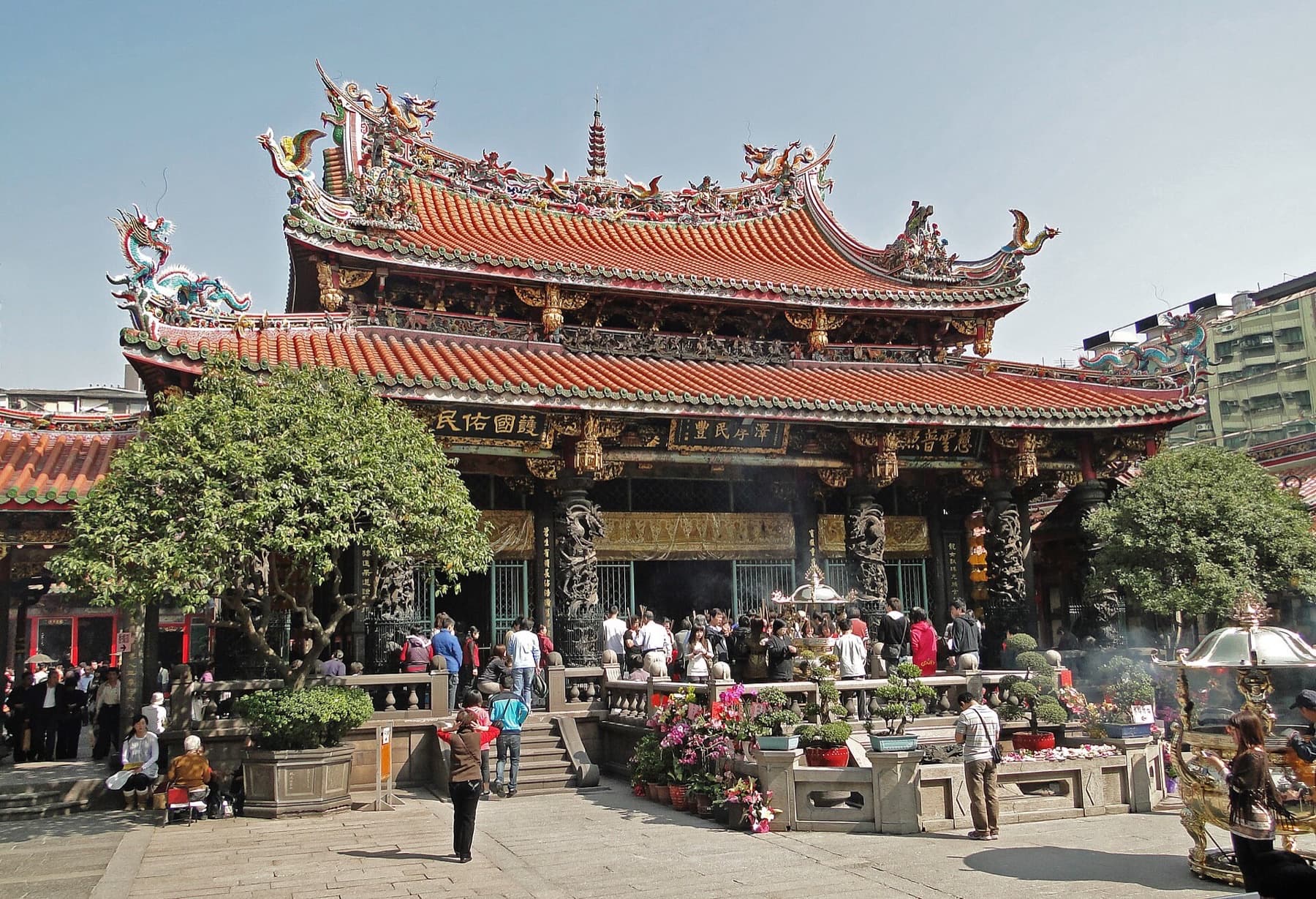 Courtyard at Longshan Temple in Taipei’s Wanhua District, with worshippers and incense