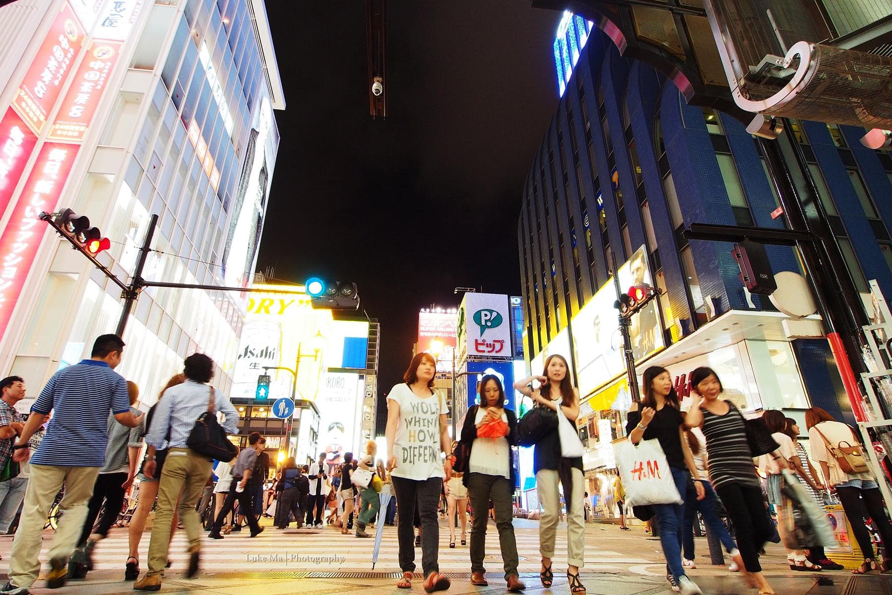 Crowds fill Shinsaibashi shopping street in Osaka at night under bright storefront lights