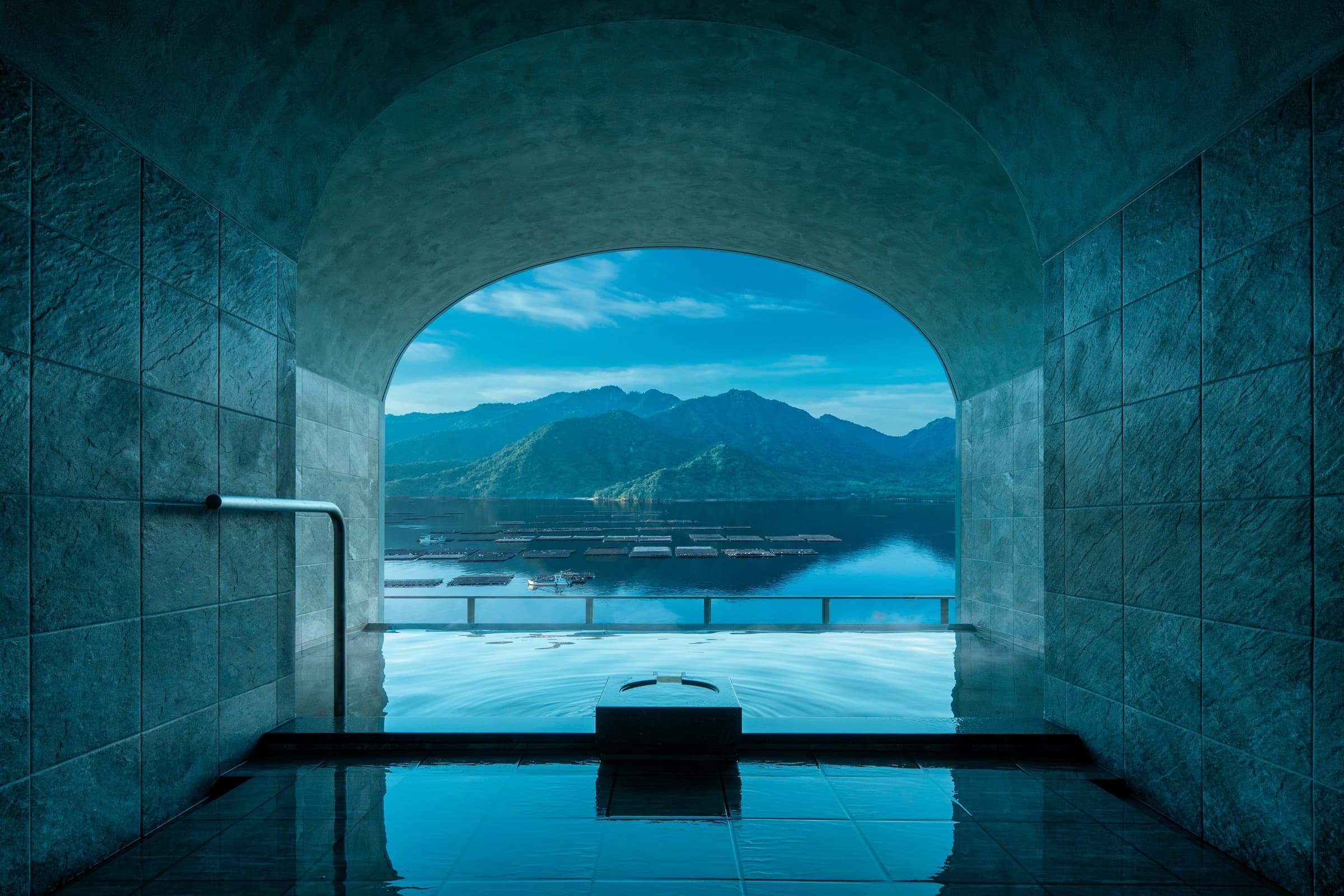 Top-floor outdoor onsen at KAI Miyajima framing the Seto Inland Sea and oyster rafts — Sleep Facing Miyajima Without the Island Crowds