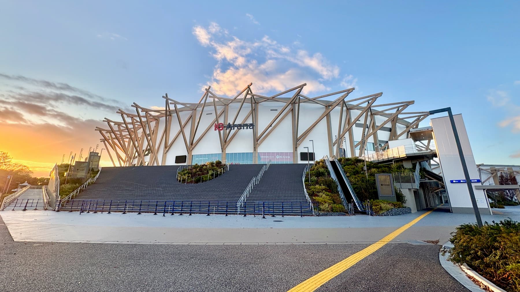 The Aichi International Arena glowing at dusk beside Meijo Park in Nagoya