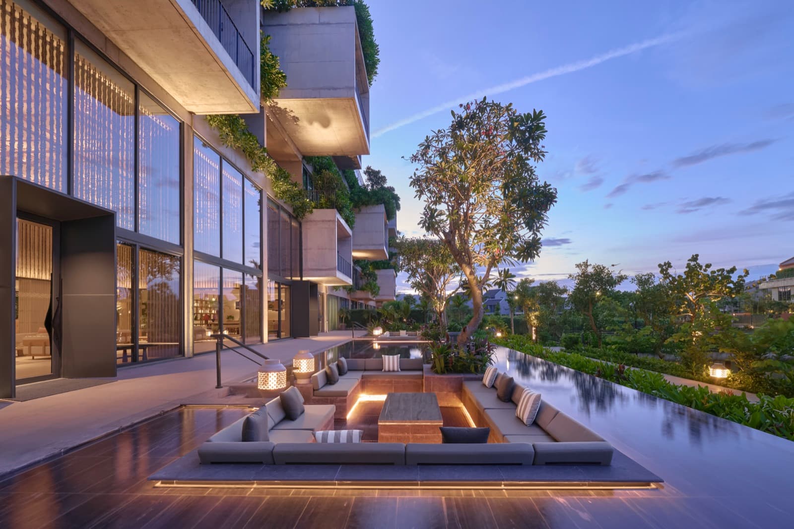 Sunken seating and a reflection pool in the open-air lobby at NHAAN Resort & Spa Hoi An