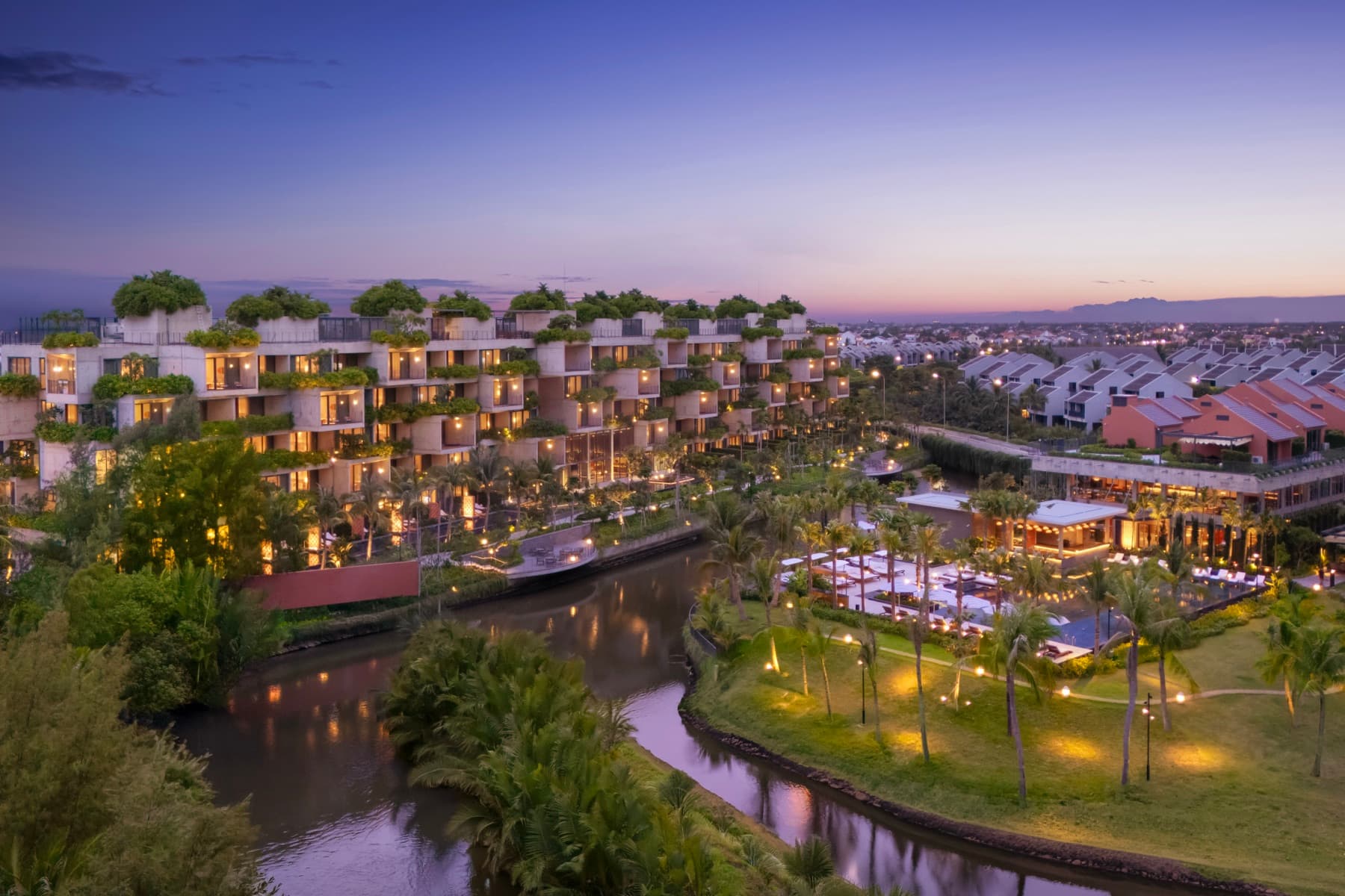 Aerial view of NHAAN Resort & Spa Hoi An beside the Cam Thanh waterways at dusk