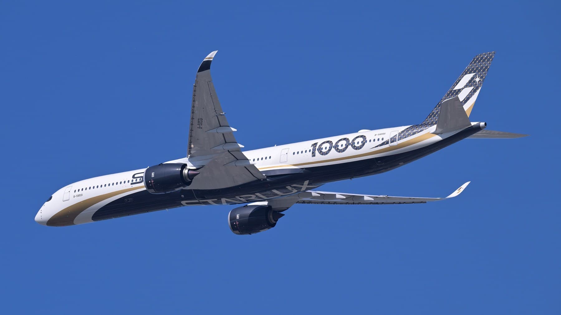 STARLUX Airlines Airbus A350-1000 climbing out of Taiwan Taoyuan against a clear blue sky — STARLUX’s Fast Rise Starts With an Ousted EVA Chairman