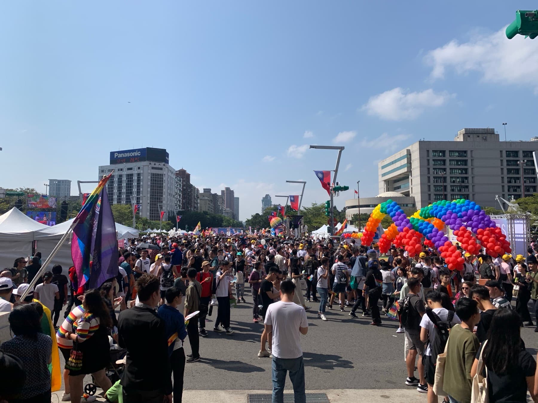 Crowd at the opening of Taiwan Pride 2019 at Taipei City Hall plaza, under rainbow arches — October Is Taiwan’s Pride, and That Changes the Diaspora Trip