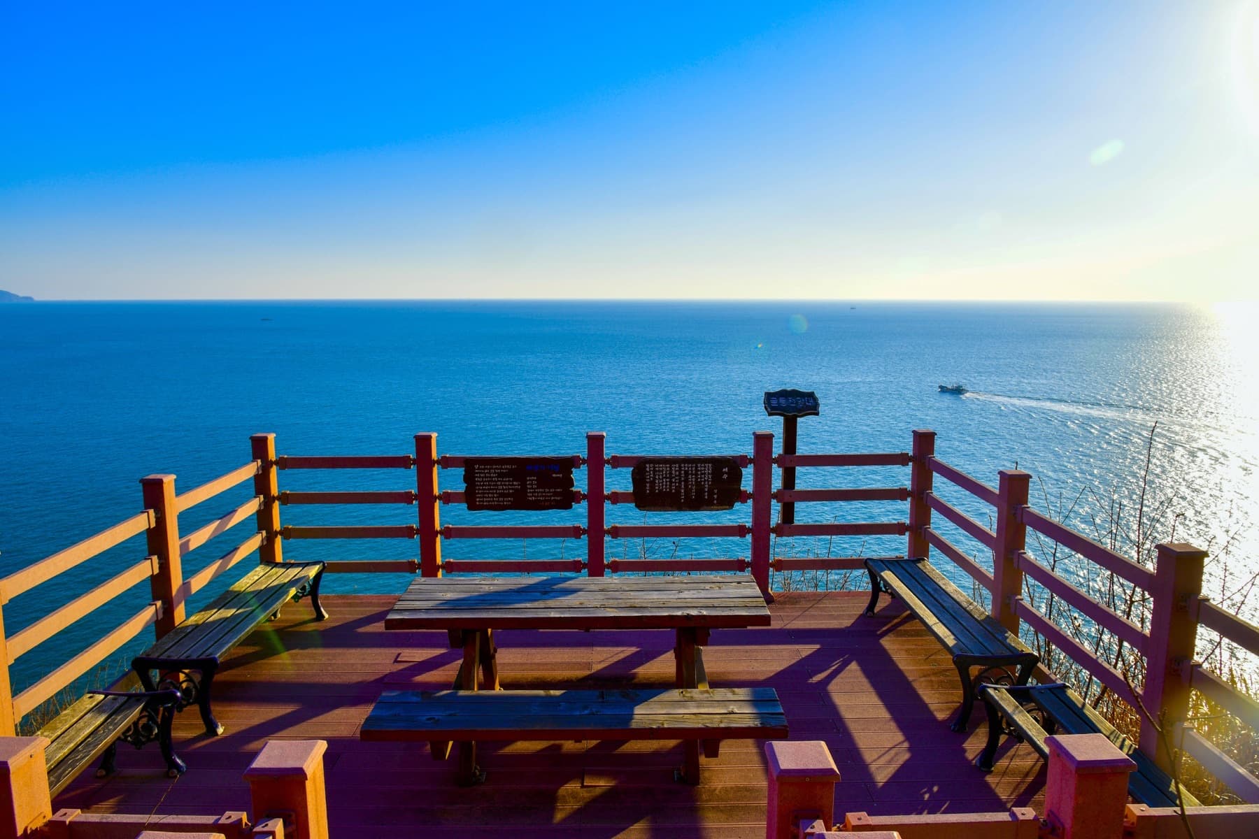 A wooden cliff deck overlooking open water on Geumodo Island near Yeosu