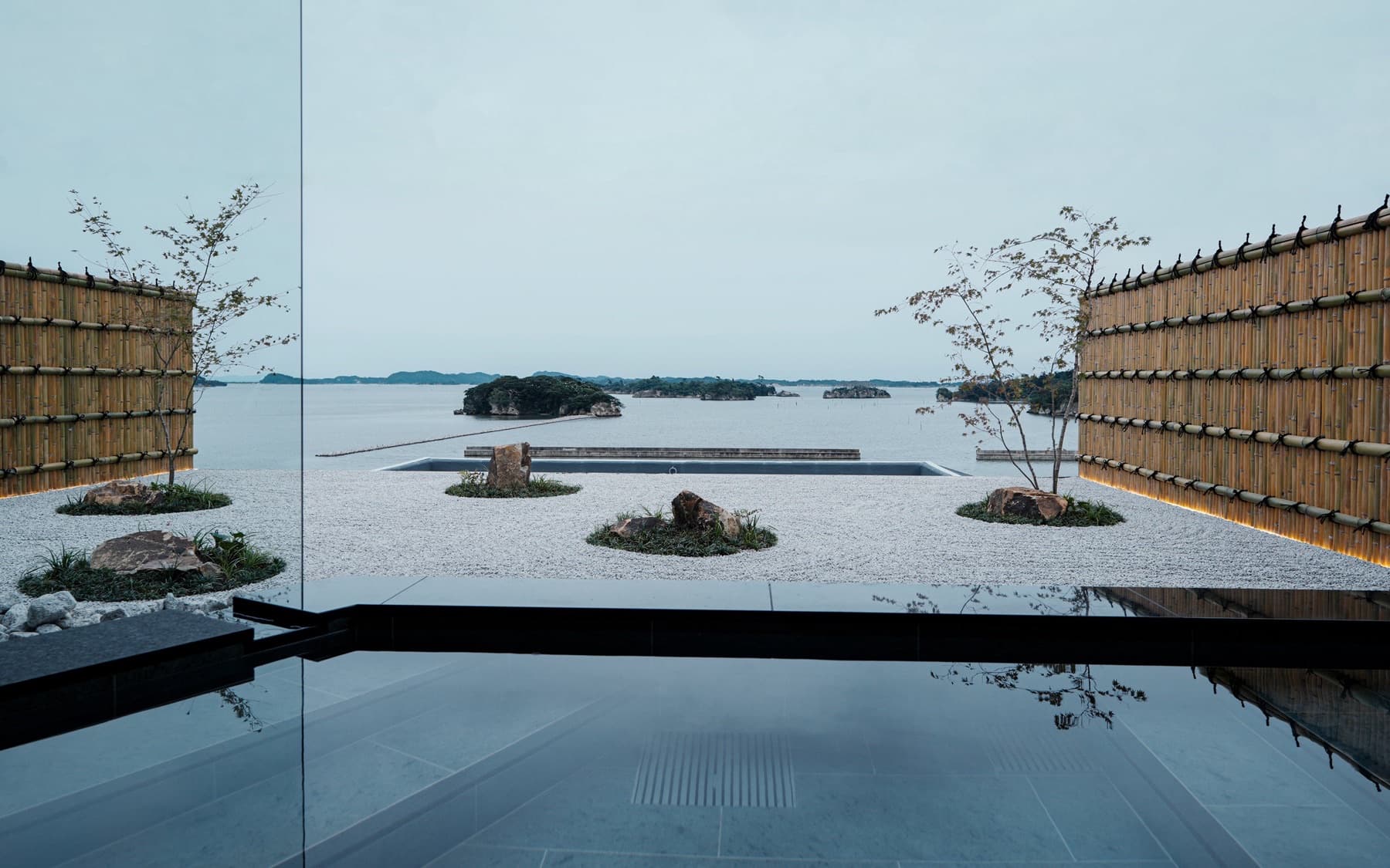 Bamboo-framed terrace and still water looking out to pine-covered islands in Matsushima Bay from YOKI MATSUSHIMA — A 26-Room Onsen Hotel Just Made Matsushima Worth the Overnight