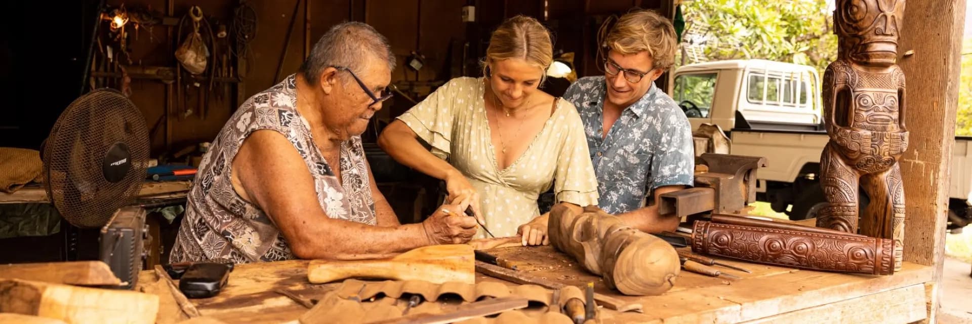 Woodcarving workshop with visitors in the Marquesas, French Polynesia