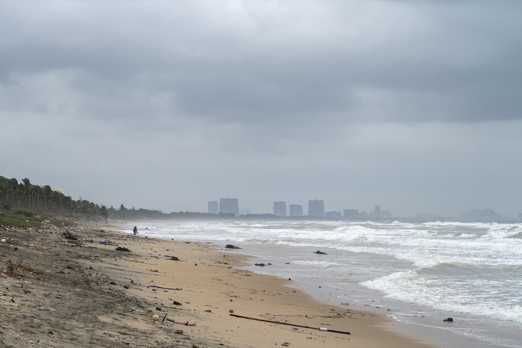 Sandy shoreline and loungers at An Bang Beach near Hoi An