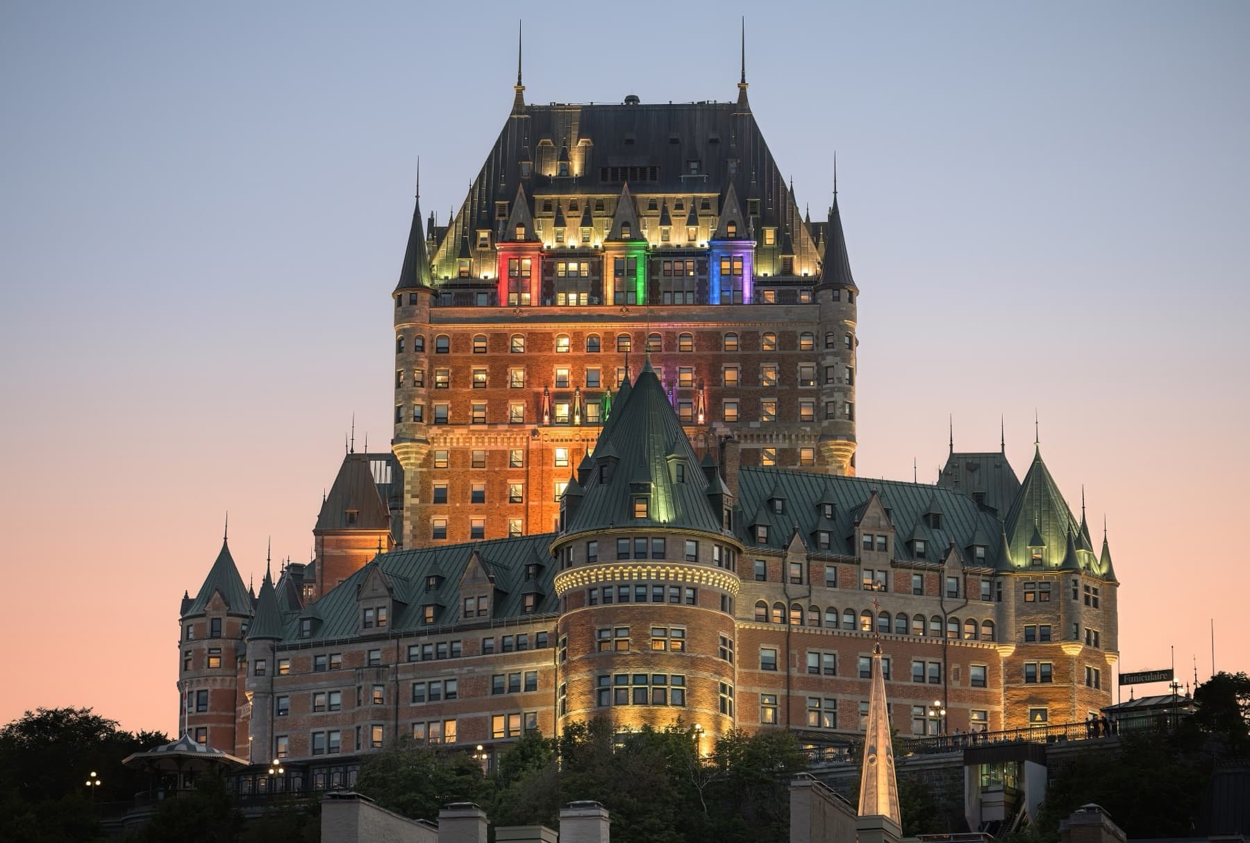 Château Frontenac lit at dusk above the old fortifications of Québec City