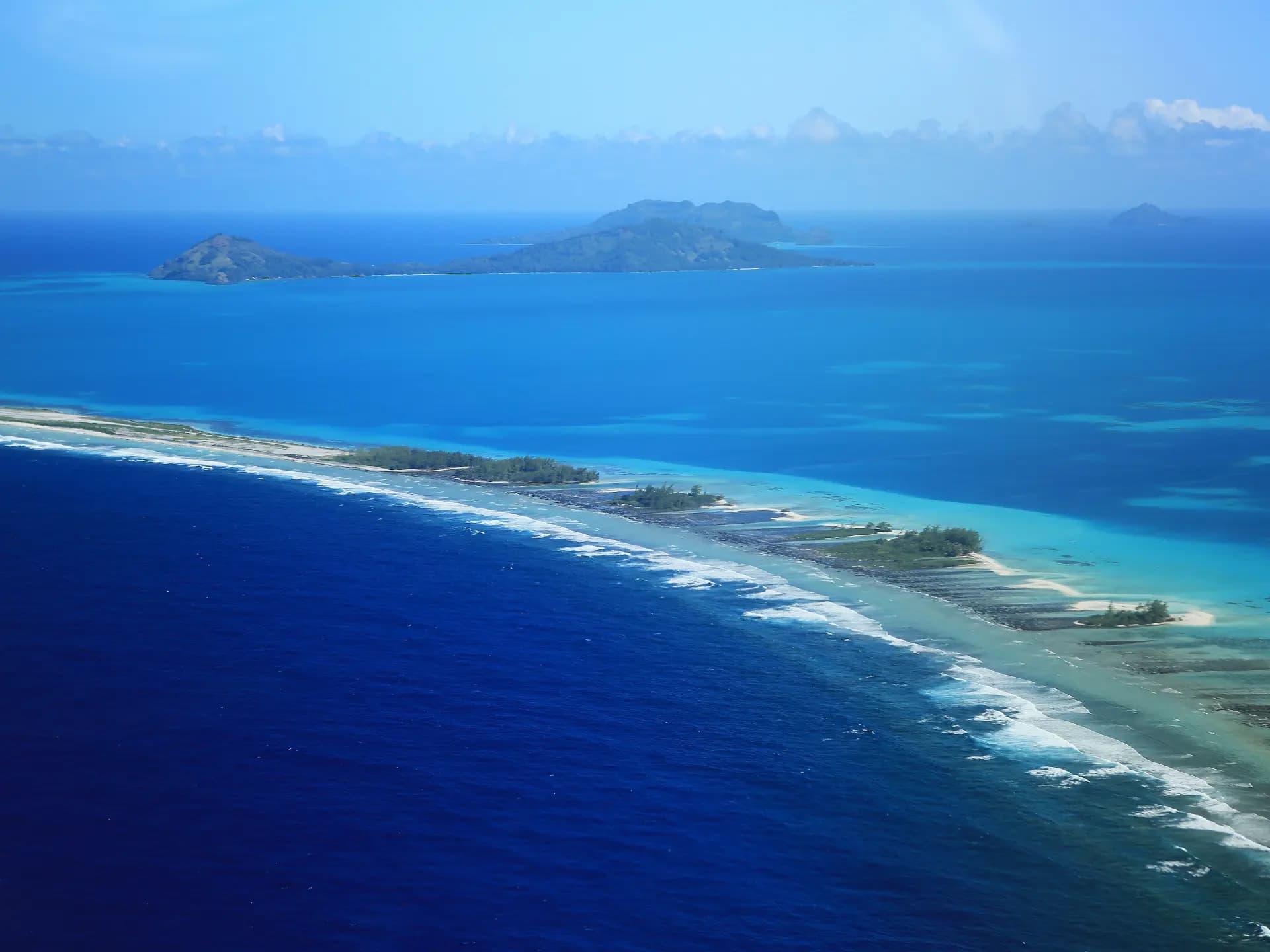 Aerial reef and motu in French Polynesia